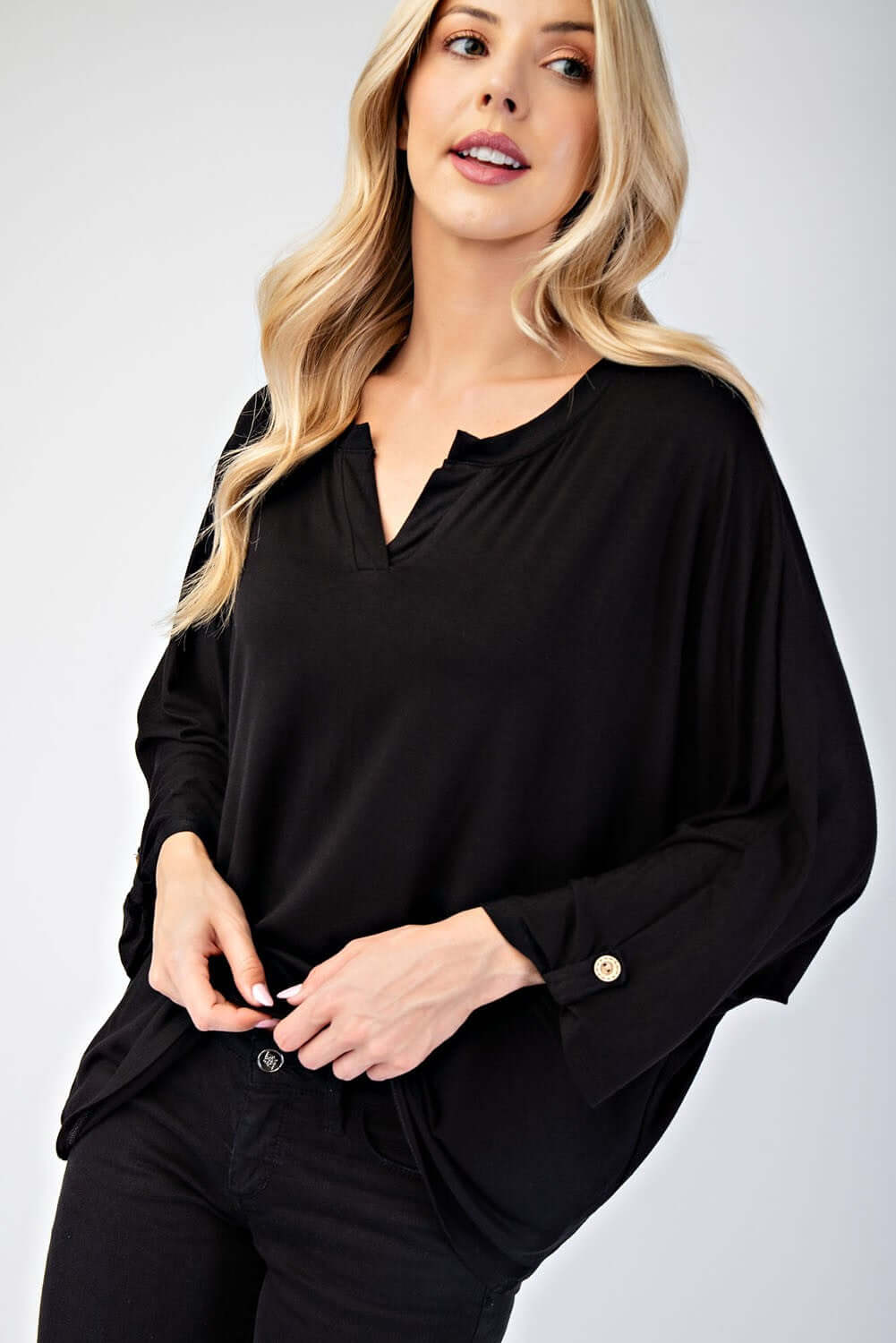 Model wearing a black Celeste Notched Three-Quarter Sleeve Blouse, showcasing its stylish design and modern neckline.