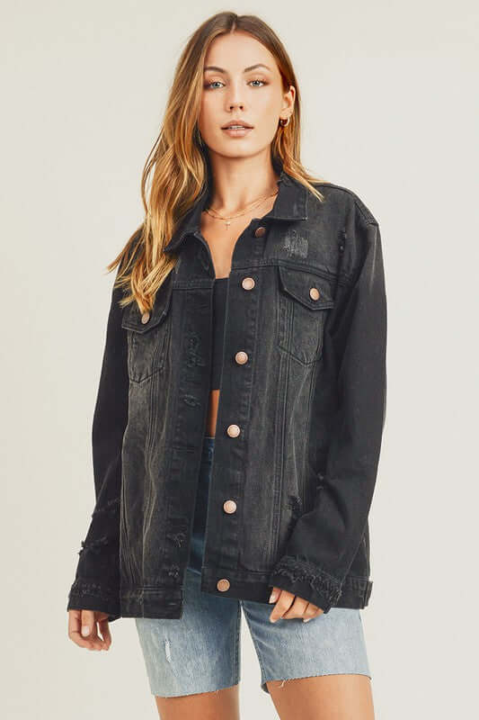 Stylish woman in a distressed long sleeve denim jacket, perfect for casual layering over outfits.