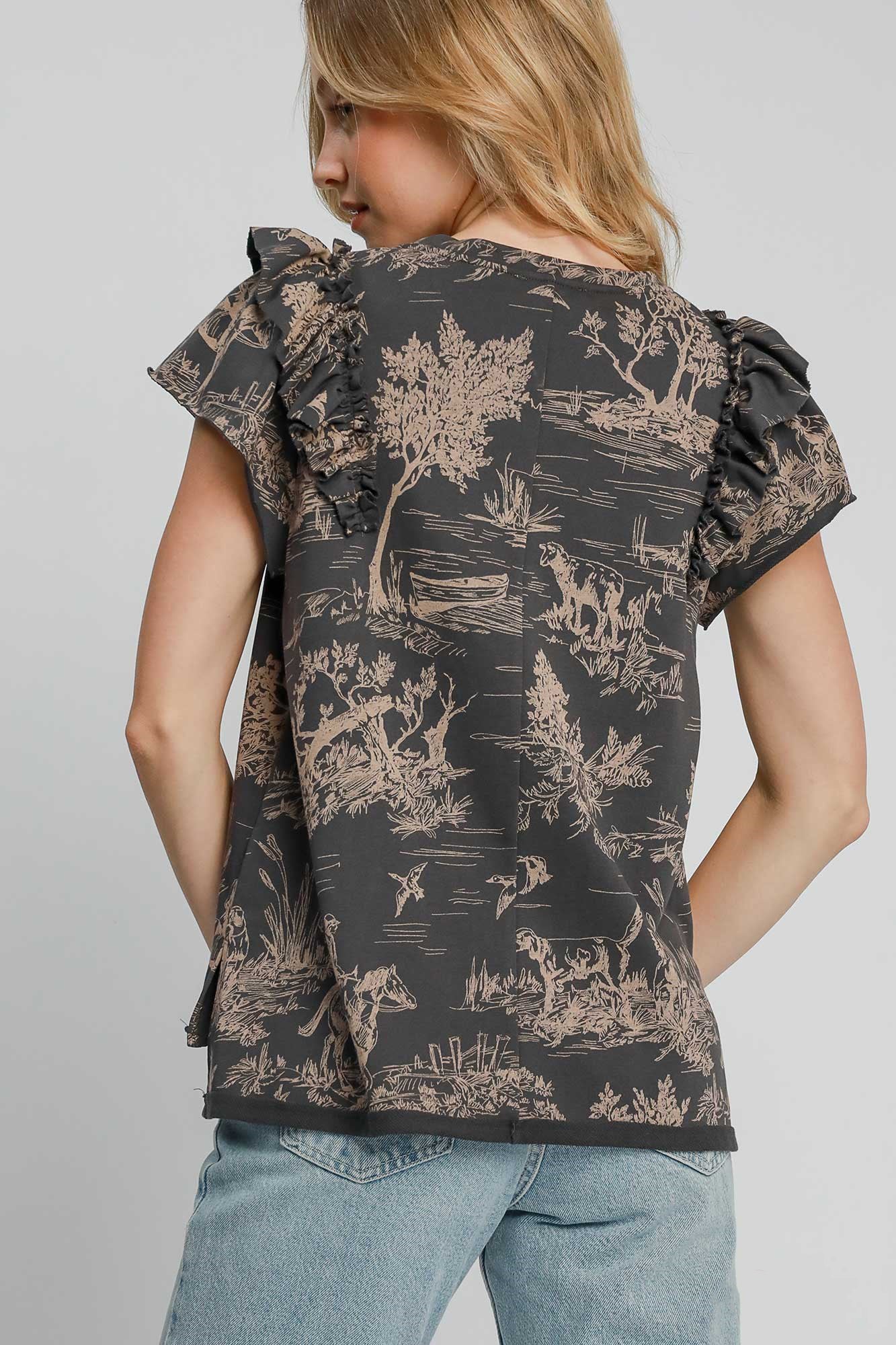 Stylish back view of the Umgee ruffled landscape print short sleeve top in French terry, featuring whimsical print details.