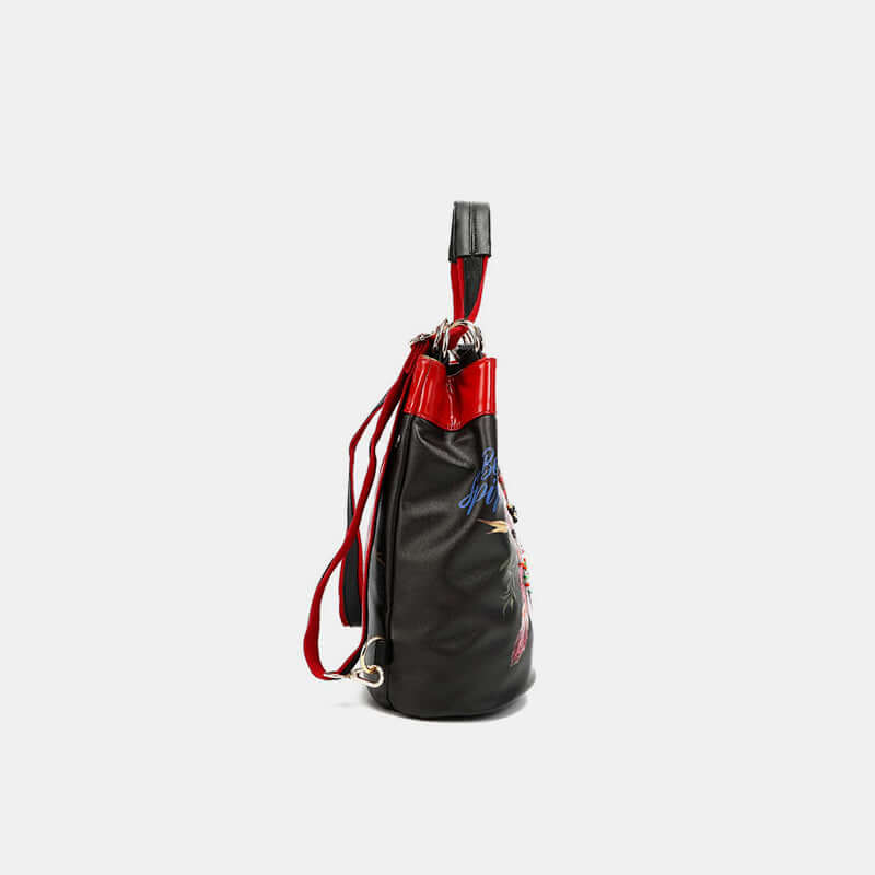 Nicole Lee USA versatile bucket bag backpack side view with adjustable straps and stylish red accents.