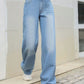 Stylish Bella Road Denim Mid Rise Wide Leg Jeans in light blue, perfect for a trendy and comfortable look.