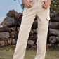 Woman wearing Bella Road High Waist Cargo Straight Jeans in beige standing outdoors.