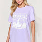 Woman wearing a purple graphic round neck short sleeve T-shirt with Nashville country music design.