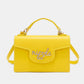 Nicole Lee USA small yellow crossbody wallet with detachable strap and multiple compartments, made from vegan leather.