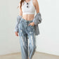 Fashion-forward individual wearing Washed Barrel Leg High Waist Distressed Jeans with trendy barrel leg cut and destroyed detailing.