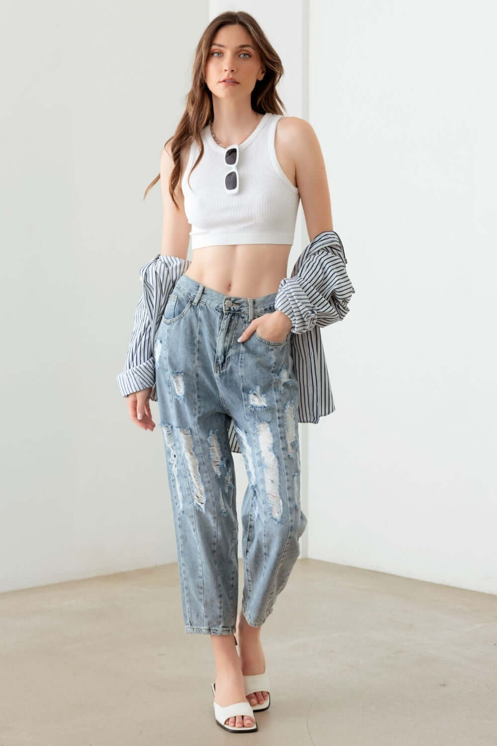 Fashion-forward individual wearing Washed Barrel Leg High Waist Distressed Jeans with trendy barrel leg cut and destroyed detailing.