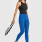 Woman in stylish blue high waist yoga leggings and black top, ready for a workout with a gym bag in hand.