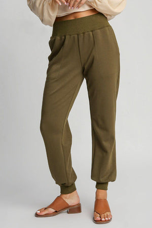 Plus size high rise elastic waist knit joggers in olive green with pockets, perfect for lounging and casual wear.