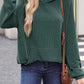 Woman wearing a green textured kangaroo pocket long sleeve hoodie with jeans and a crossbody bag