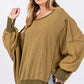 Woman wearing Mineral Wash Side Slit Oversized Sweatshirt with wide scoop neck and exposed seams for a trendy, edgy look.