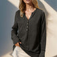 Woman wearing Double Take Full Size Notched Thumbhole Long Sleeve T-Shirt in black, featuring notched neckline and thumbholes.