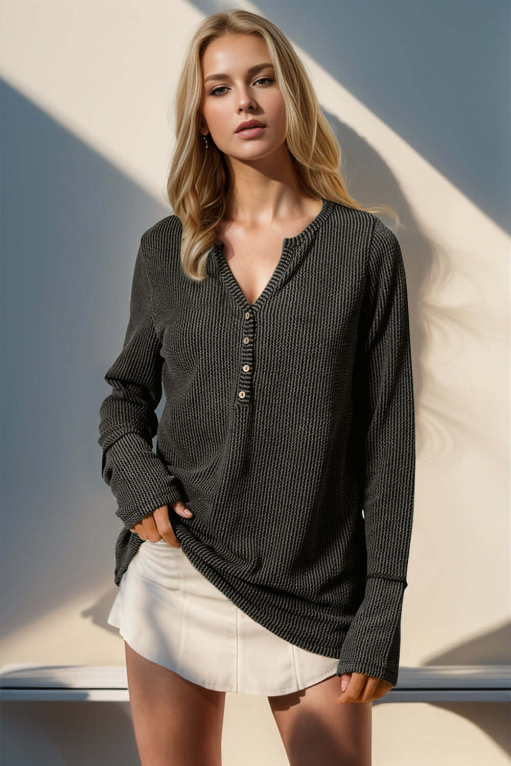 Woman wearing Double Take Full Size Notched Thumbhole Long Sleeve T-Shirt in black, featuring notched neckline and thumbholes.