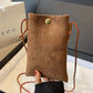 Person holding Bella Road Suede Snap Down Crossbody Bag with snap-down design and crossbody strap