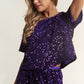 Woman wearing a dazzling sequin short sleeve crop T-shirt in purple, perfect for stylish evenings or casual gatherings.