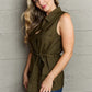 Woman wearing Follow The Light Sleeveless Collared Button Down Top paired with jeans, showcasing chic and comfortable fashion ideal for warmer weather.