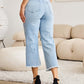 Woman wearing Tummy Control High Waist Raw Hem Distressed Jeans | Petite, showing back and raw hem details. RFM Jeans