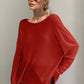 Trendy rust high-low long sleeve T-shirt worn by a stylish person with sunglasses, exuding relaxed and playful vibes.