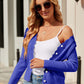 Woman wearing Bella Road Button Up Long Sleeve Cardigan in blue, paired with white top and sunglasses, standing outside.