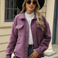 Woman wearing Bella Road Plaid Collared Jacket with long sleeves, sunglasses, hat, and holding a clutch.