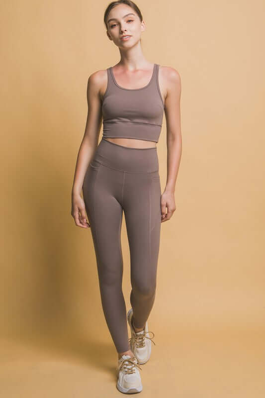 Model showcasing Love Tree high waist leggings and crop top, perfect for workouts and casual outings.