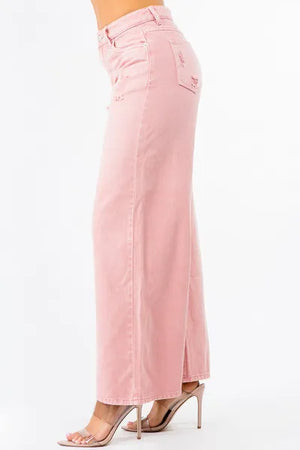 Trendy pink high waist distressed wide leg jeans with a relaxed fit, perfect for chic styling.