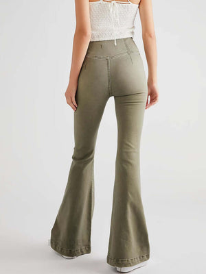 Woman wearing Asymmetric Waist Flare Jeans in olive green, showing back view with flared legs and unique waist design