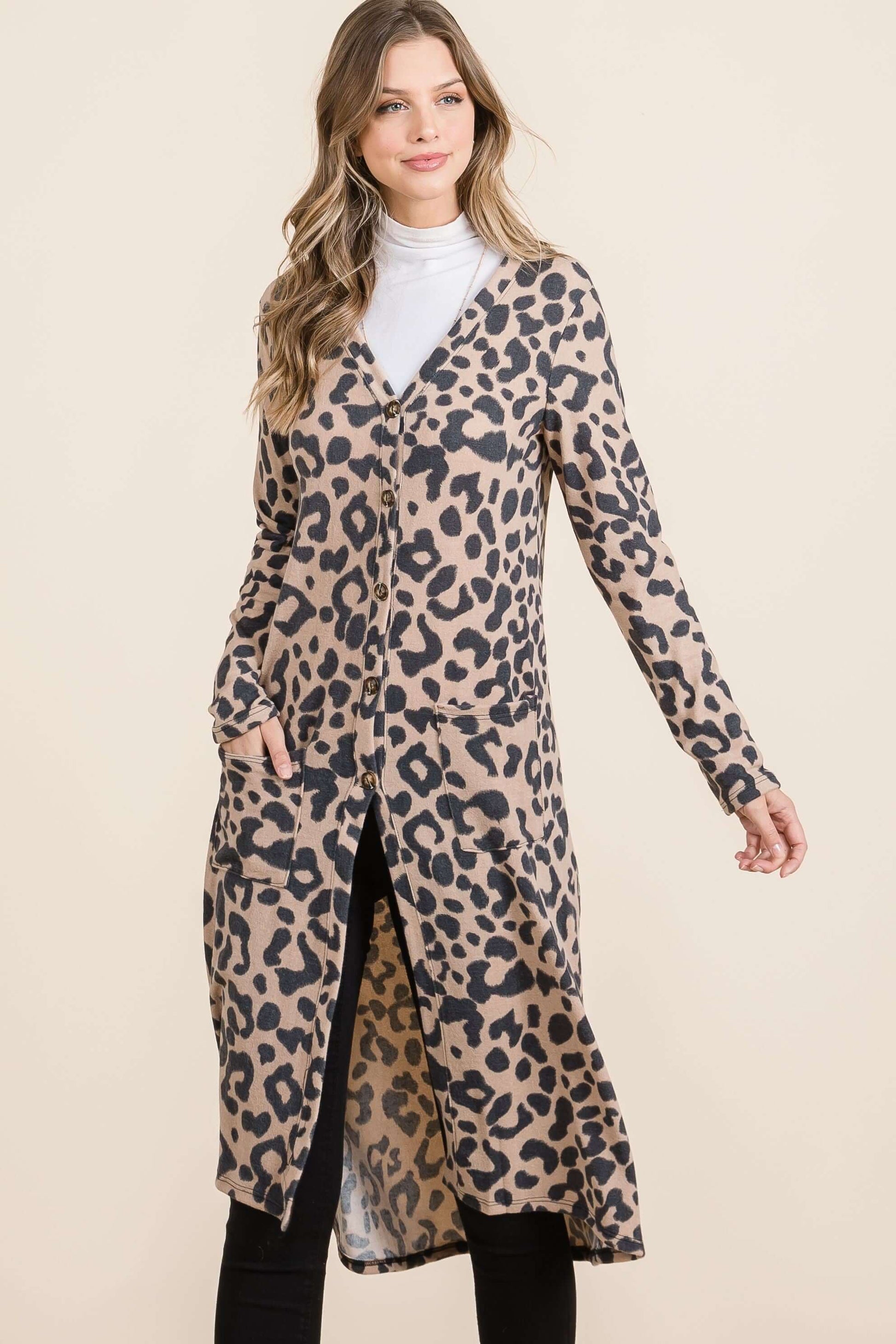 Stylish model wearing a Celeste Full Size Leopard V-Neck Long Sleeve Cardigan, showcasing its trendy leopard print and cozy design.