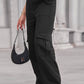 Woman wearing Baeful Long Straight Leg Jeans with Pockets in black, paired with a small handbag and chunky shoes.