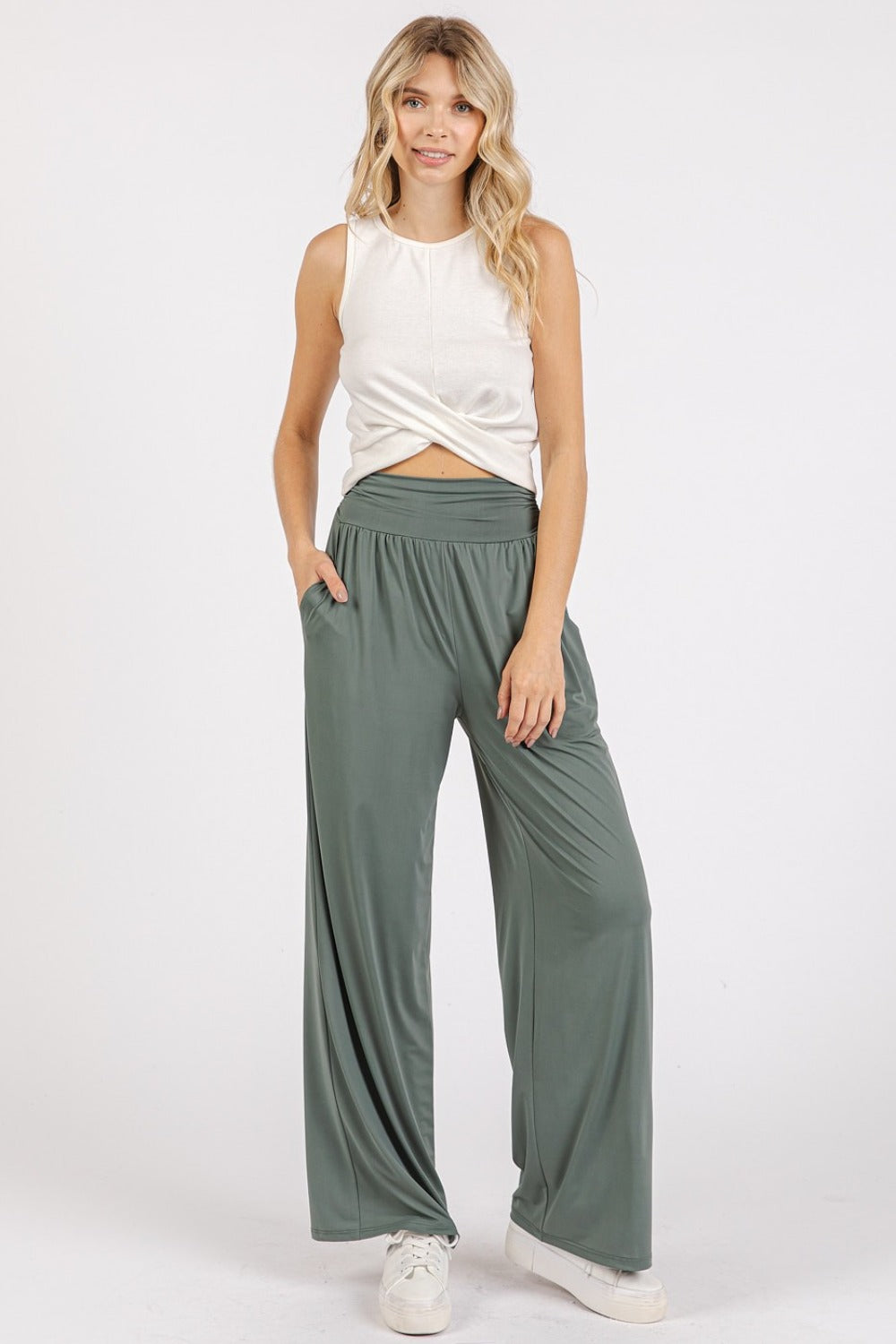 Woman wearing Mittoshop stretch banded waist wide leg pants with pockets, paired with a white top, showcasing a stylish and comfortable outfit.