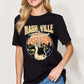 Woman wearing Graphic Round Neck Short Sleeve T-Shirt with Nashville Tennessee guitar print, paired with blue jeans.