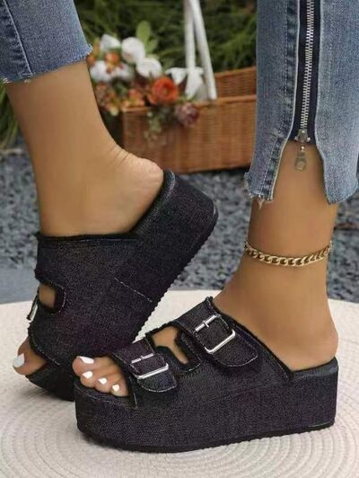 Bella Road Raw Hem Wedge Buckle Sandals in black worn with denim jeans, showcasing stylish design and mid heel comfort.