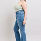 Model showcasing Judy Blue high waist tummy control vintage wash slim boot jeans with side slit detail.