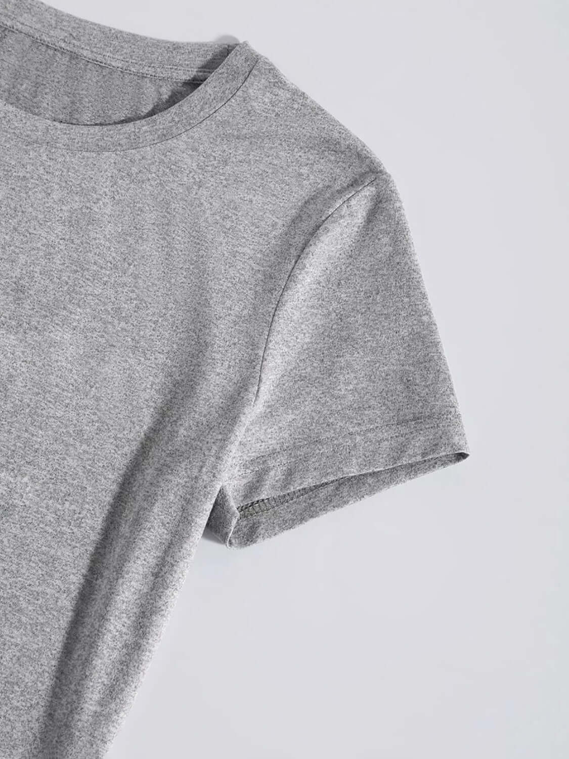 Close-up of a gray graphic round neck short sleeve T-shirt made of slightly stretchy 100% polyester material.