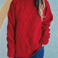 Woman wearing Bella Road Diamond Round Neck Long Sleeve Sweater in red with unique diamond pattern and jeans