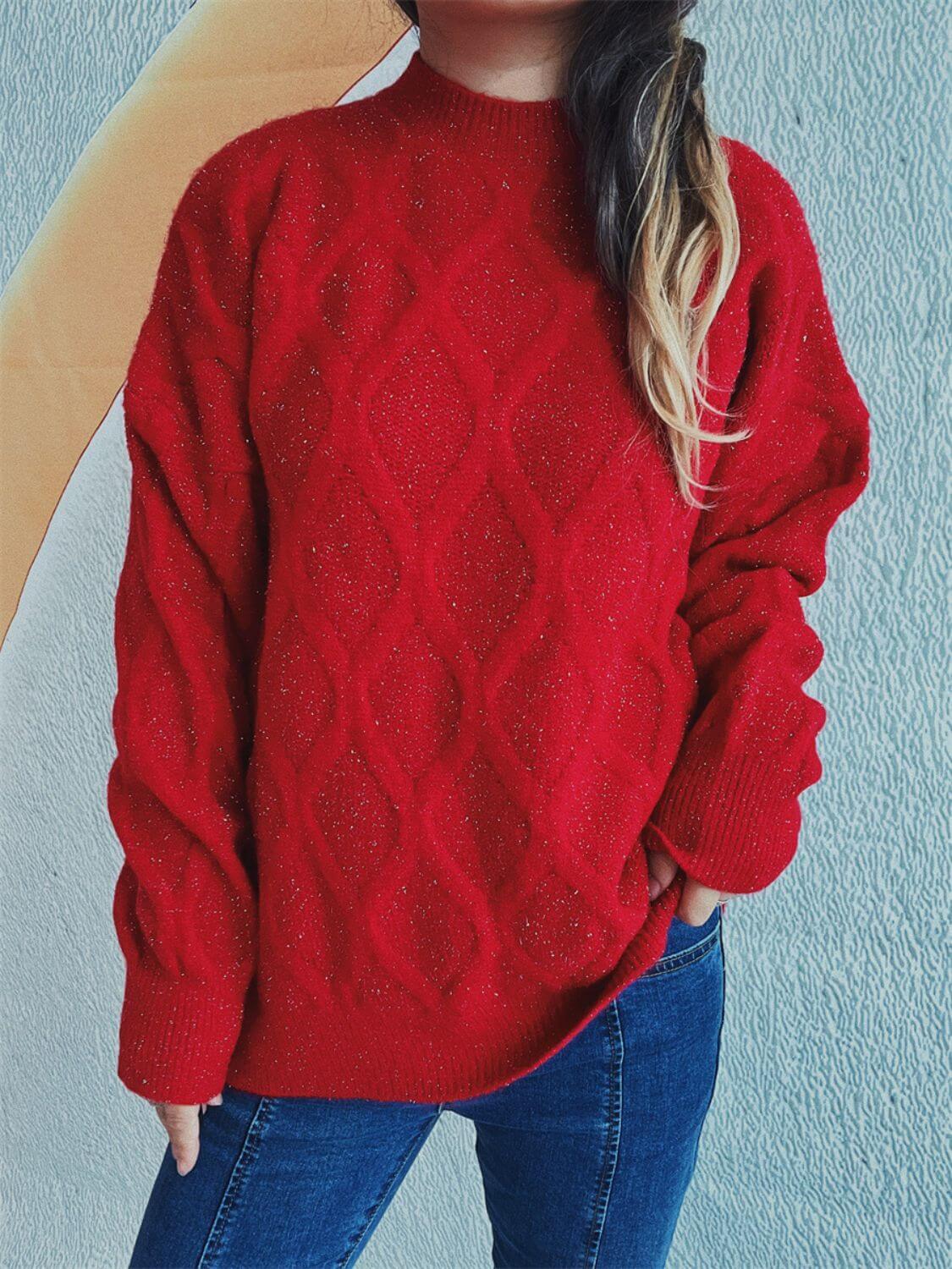 Woman wearing Bella Road Diamond Round Neck Long Sleeve Sweater in red with unique diamond pattern and jeans