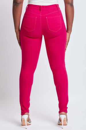 Back view of Hyperstretch Mid-Rise Skinny Jeans in vibrant pink, showcasing slim fit and mid-rise waist by YMI Jeans