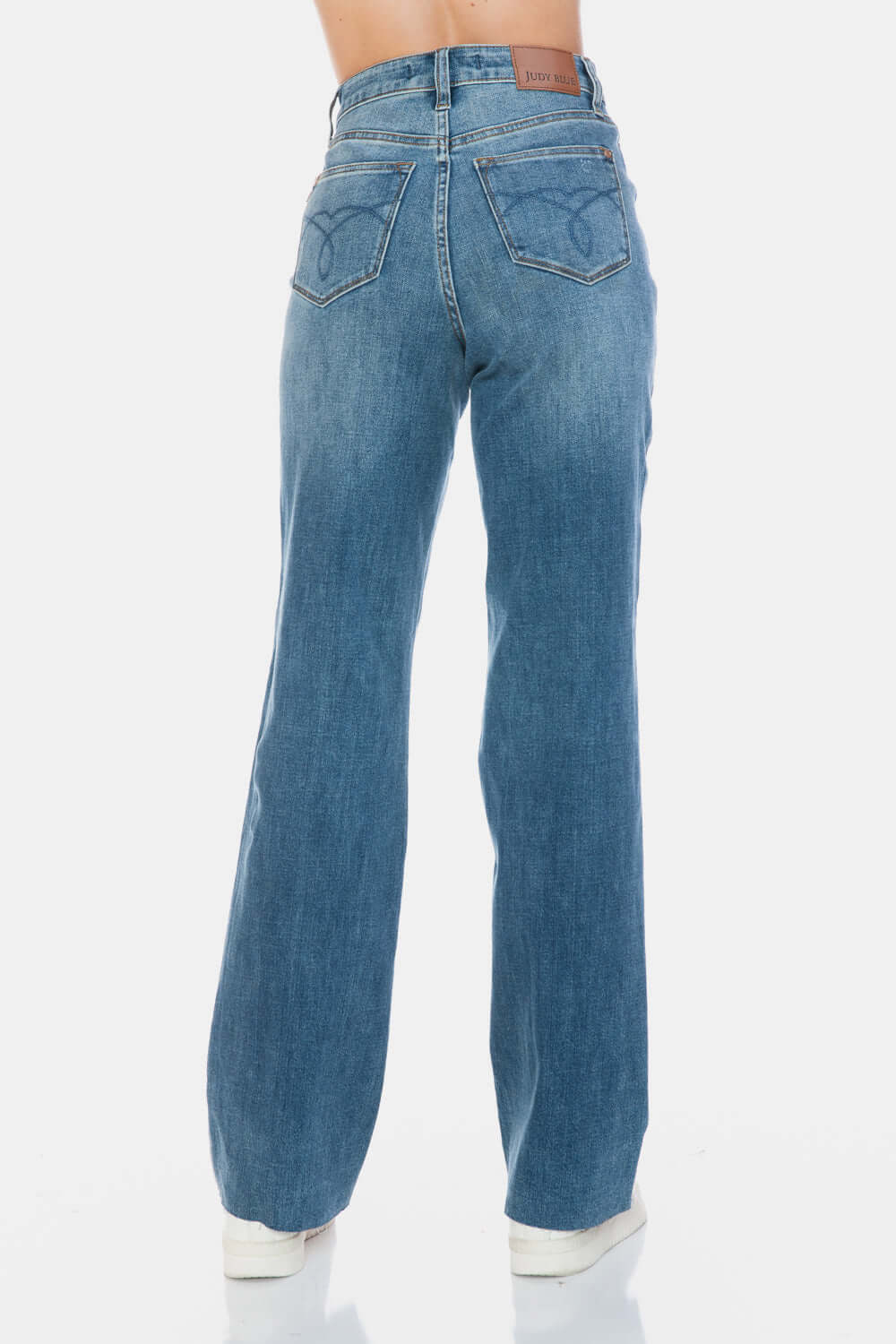 Back view of Judy Blue Tummy Control Cut Raw Hem Straight Jeans showcasing high-waist and trendy raw hem design.