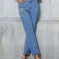 Bella Road Denim butterfly embroidered straight leg jeans in medium wash, styled with chic heels and a trendy top.