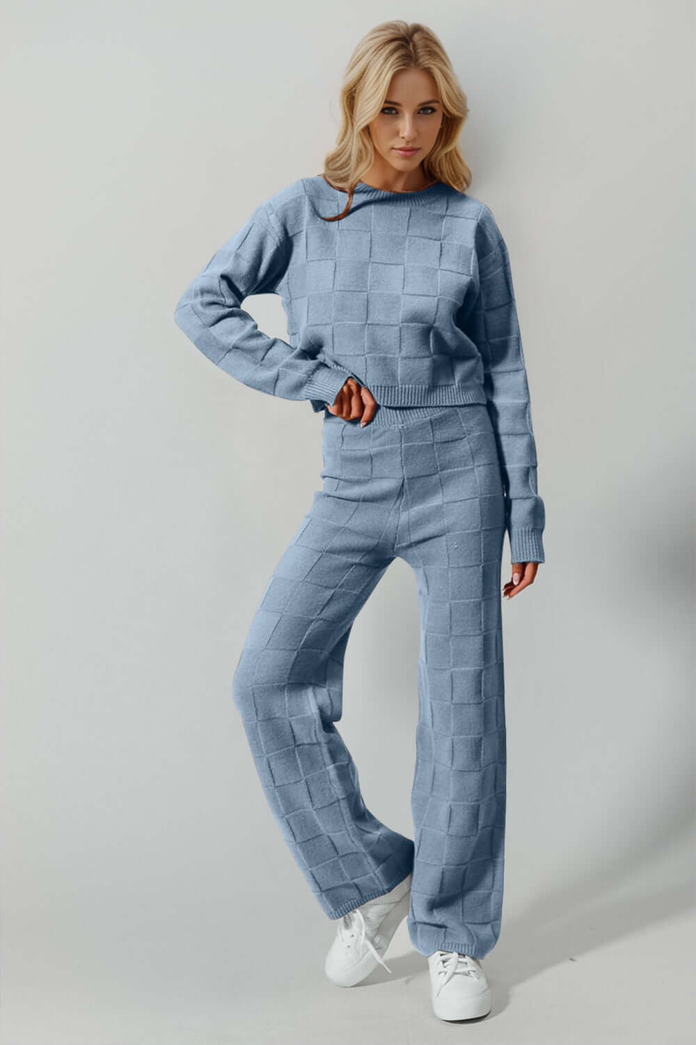 Woman wearing Double Take Checkered Round Neck Top and Pants Set in blue, showcasing stylish leisurewear with an edgy twist.