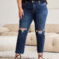 Woman wearing RFM Jeans distressed high waist raw hem jeans with tummy control, pairing with black top and strappy heels.