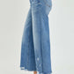 High rise side slit raw hem cropped jeans by Risen Jeans, perfect for a stylish and laid-back look, paired with clear high heels.