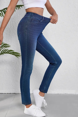 Woman wearing high waist skinny jeans with pockets, showcasing stretch and slimming fit.