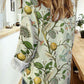 Woman wearing Bella Road Lemon Printed Collared Neck Long Sleeve Shirt with playful design and buttoned front.