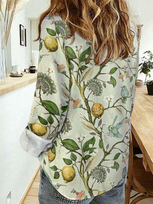 Woman wearing Bella Road Lemon Printed Collared Neck Long Sleeve Shirt with playful design and buttoned front.