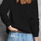 Woman's back view in a black sweatshirt paired with distressed jeans, showcasing a stylish yet comfortable look.