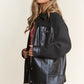 Trendy faux leather sherpa contrast jacket with snap buttons, combining sleek style and cozy warmth for versatile fashion.