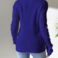 Woman wearing Bella Road openwork V-neck sweater with stylish batwing sleeves in vibrant blue, perfect for a cozy, fashionable look.