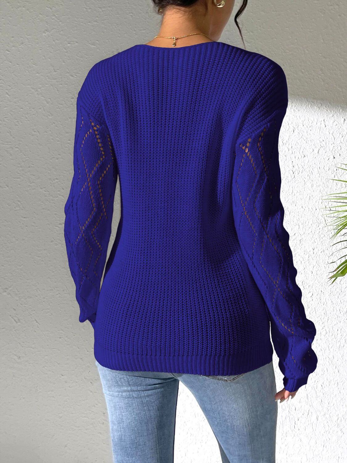 Woman wearing Bella Road openwork V-neck sweater with stylish batwing sleeves in vibrant blue, perfect for a cozy, fashionable look.