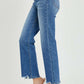 High-rise straight leg jeans with a chic streamlined look, featuring a classic blue wash and frayed hem, paired with clear high heels.