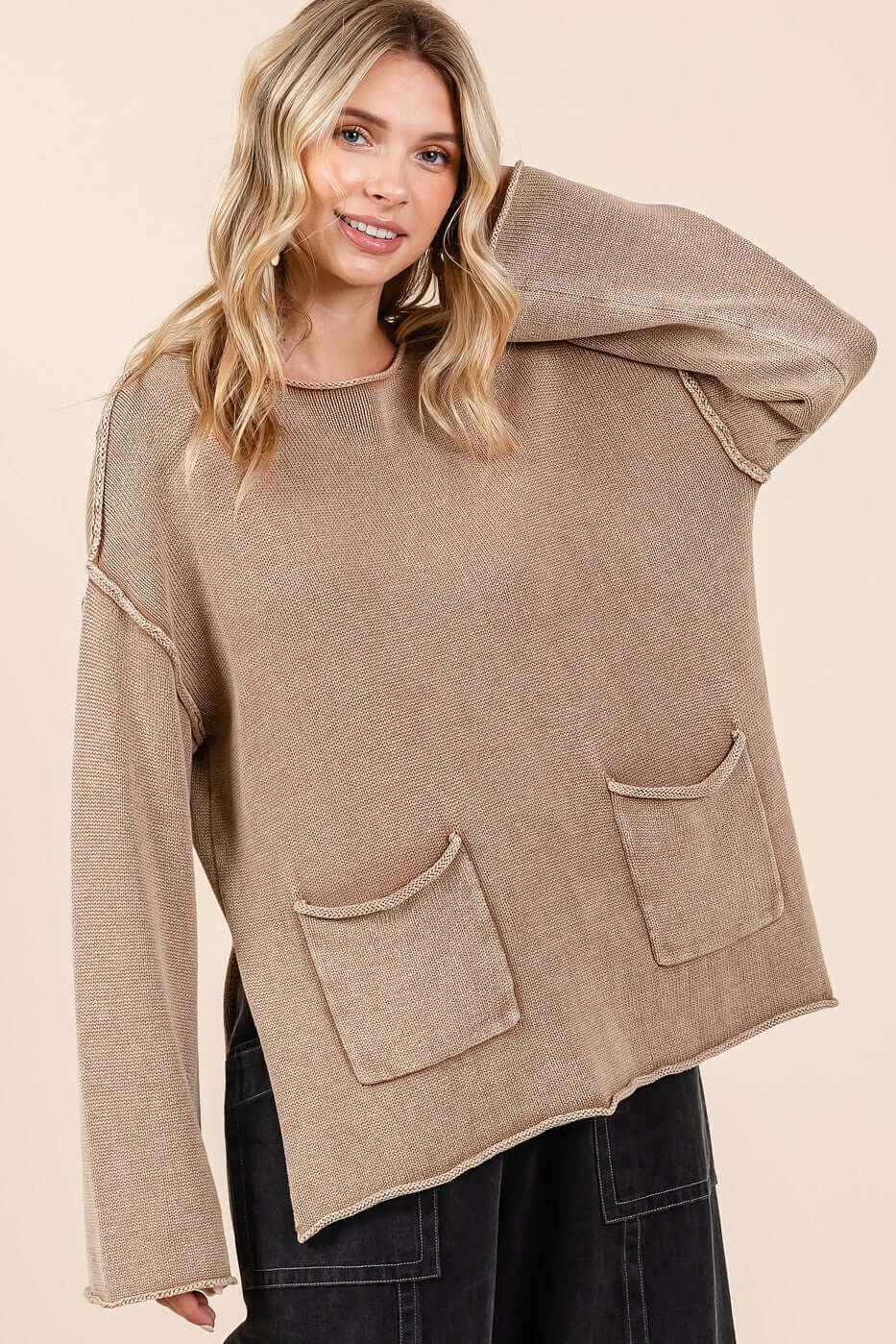 Woman wearing Mittoshop Mineral Wash Patch Pocket Cut Edge Sweater, showcasing trendy design and comfort with visible patch pockets.